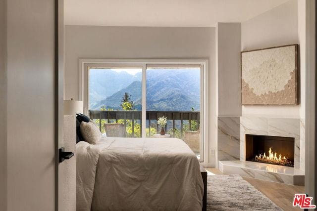 Bedroom with mountain views and fireplace